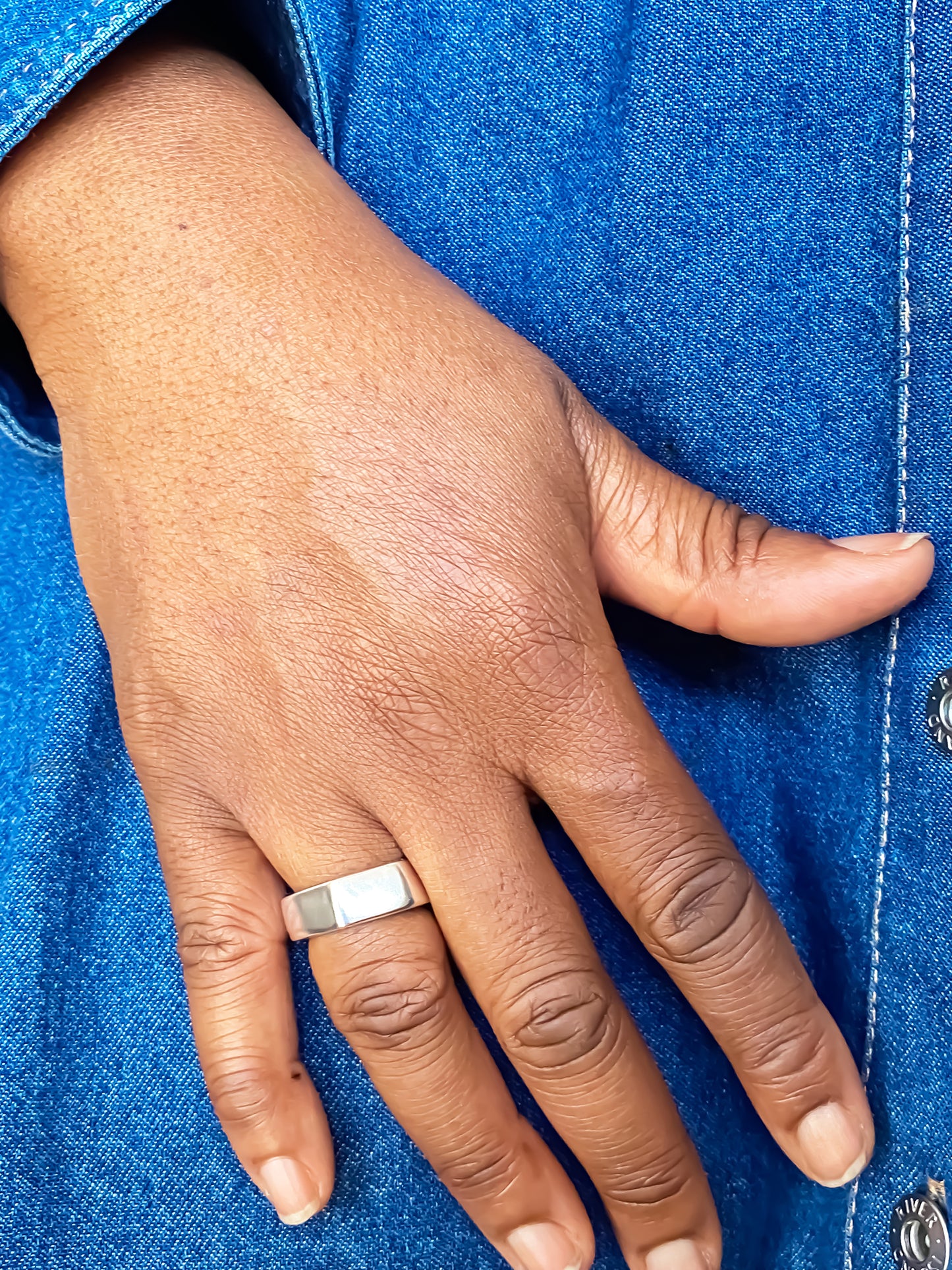 Wonky Nut Ring photographed against a bright blue background - playfully unique elegant gold or silver free shipping