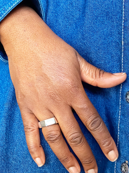 Wonky Nut Ring photographed against a bright blue background - playfully unique elegant gold or silver free shipping