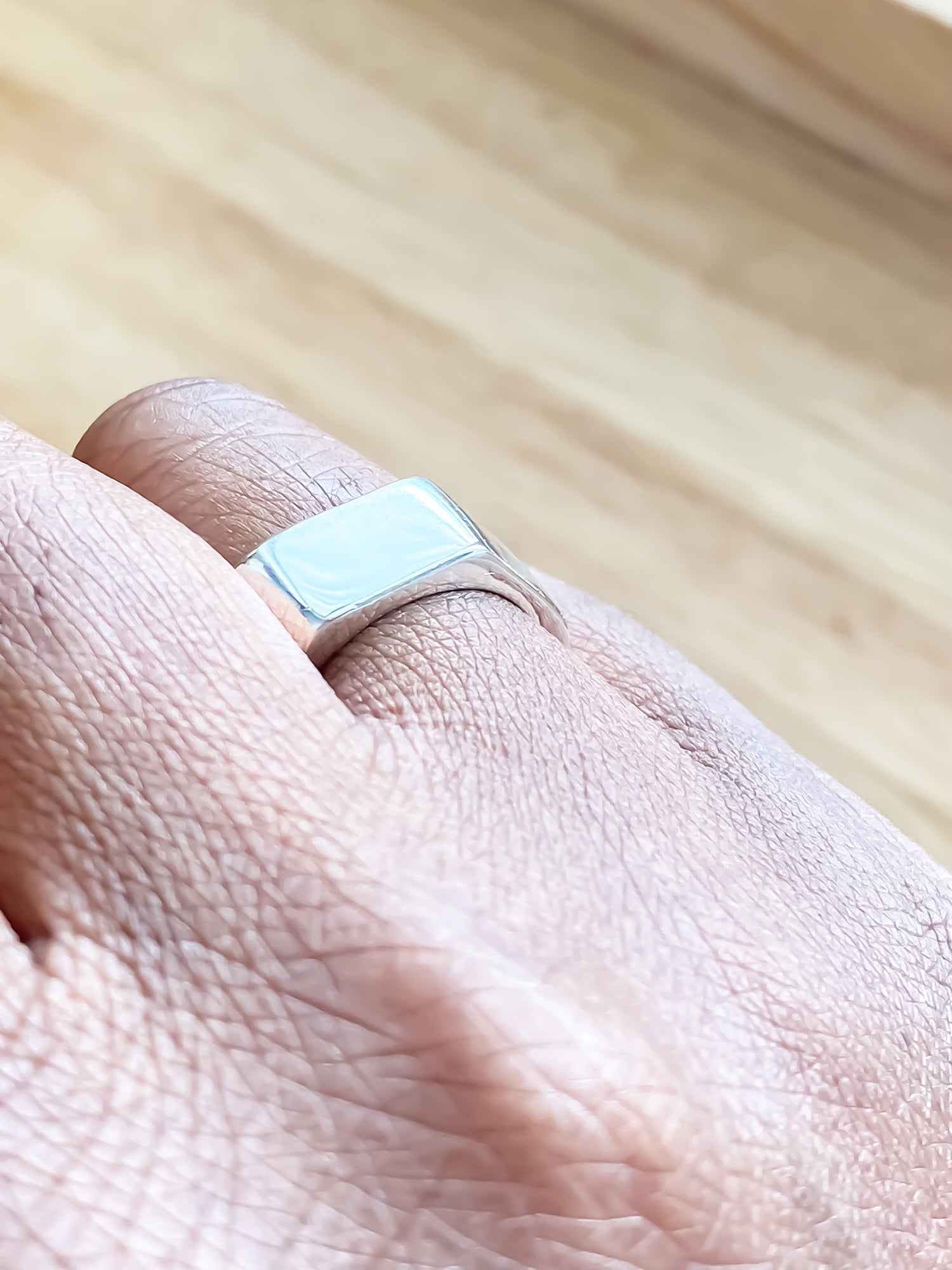Light-toned hand wearing Wonky Nut Ring - playfully unique elegant gold or silver free shipping