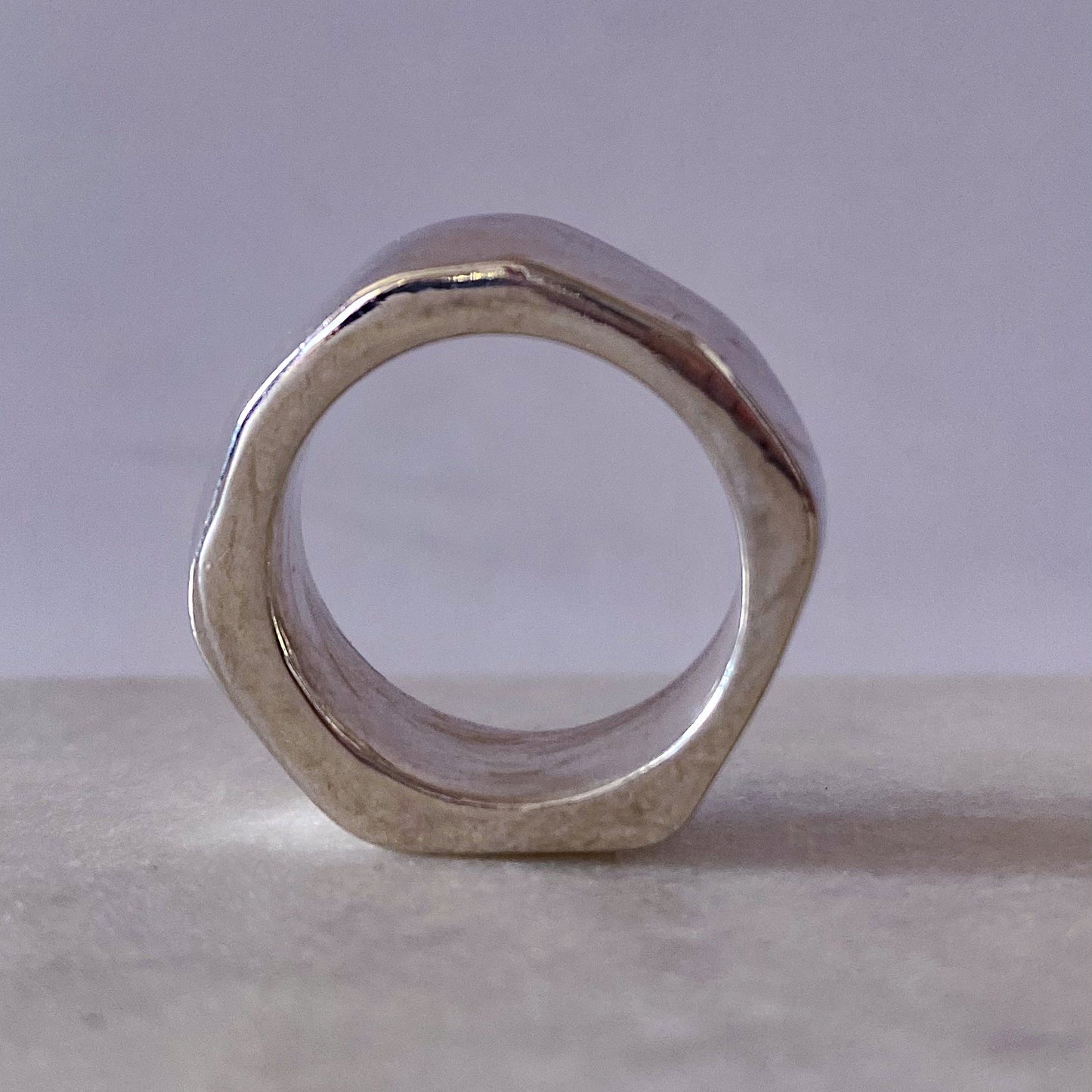 Wonky Nut Ring in silver under dramatic lighting - playfully unique elegant gold or silver free shipping