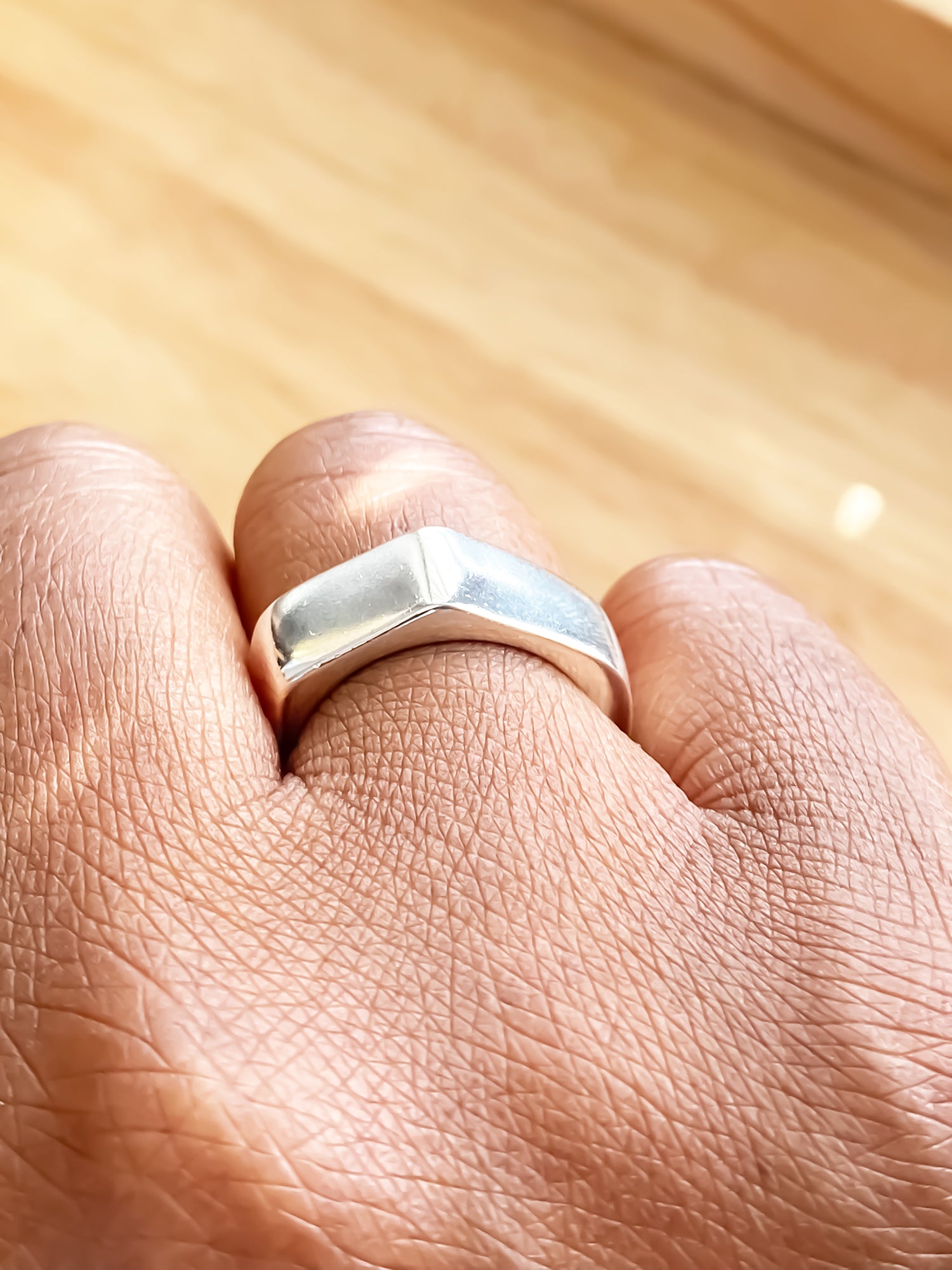 Minimalist photo of Wonky Nut Ring being worn - playfully unique elegant gold or silver free shipping